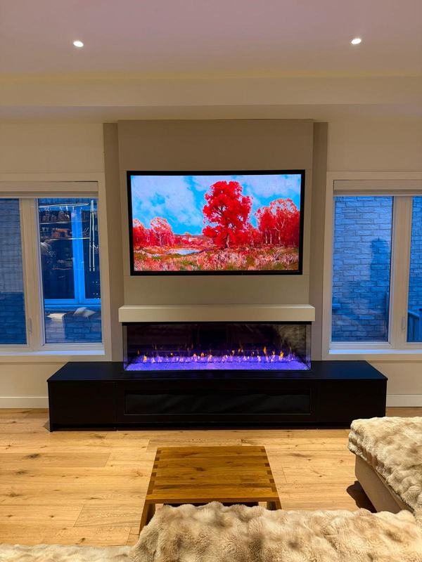 Motorized TV wall mount above a linear electric fireplace with custom MDF surround in North York